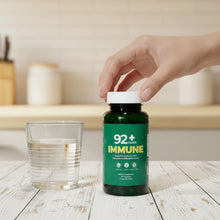 Load image into Gallery viewer, 92+ Immune Sea Moss Capsules bottle on wooden surface with yellow background
